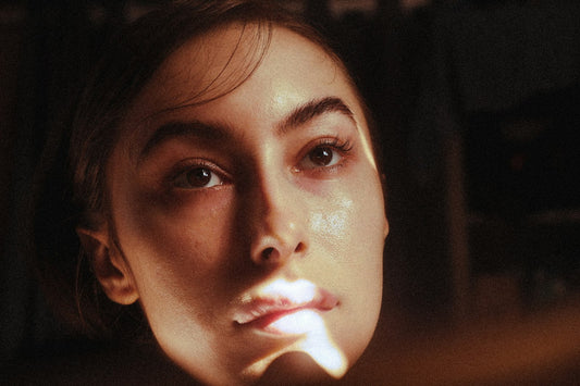 Portrait of a woman's face in soft directional light, illustrating how weight loss can change facial contours